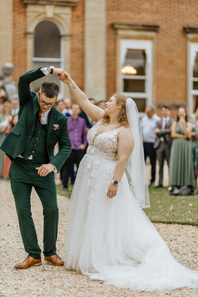 Bride and Groom dancing in the gardens at Crowcombe Court during a summer wedding in Somerset, captured by a Crowcombe Court wedding photographer.