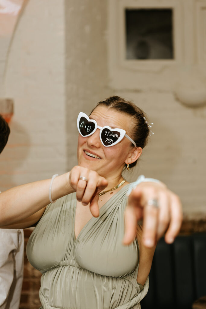 Dancing in the Undercroft at Crowcombe Court during a summer wedding in Somerset, captured by a Crowcombe Court wedding photographer.
