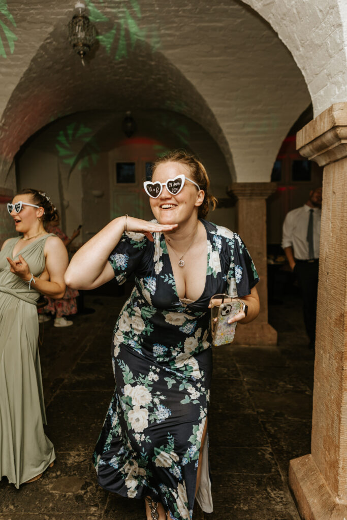 Dancing in the Undercroft at Crowcombe Court during a summer wedding in Somerset, captured by a Crowcombe Court wedding photographer.