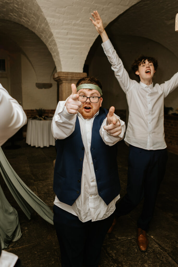 Dancing in the Undercroft at Crowcombe Court during a summer wedding in Somerset, captured by a Crowcombe Court wedding photographer.
