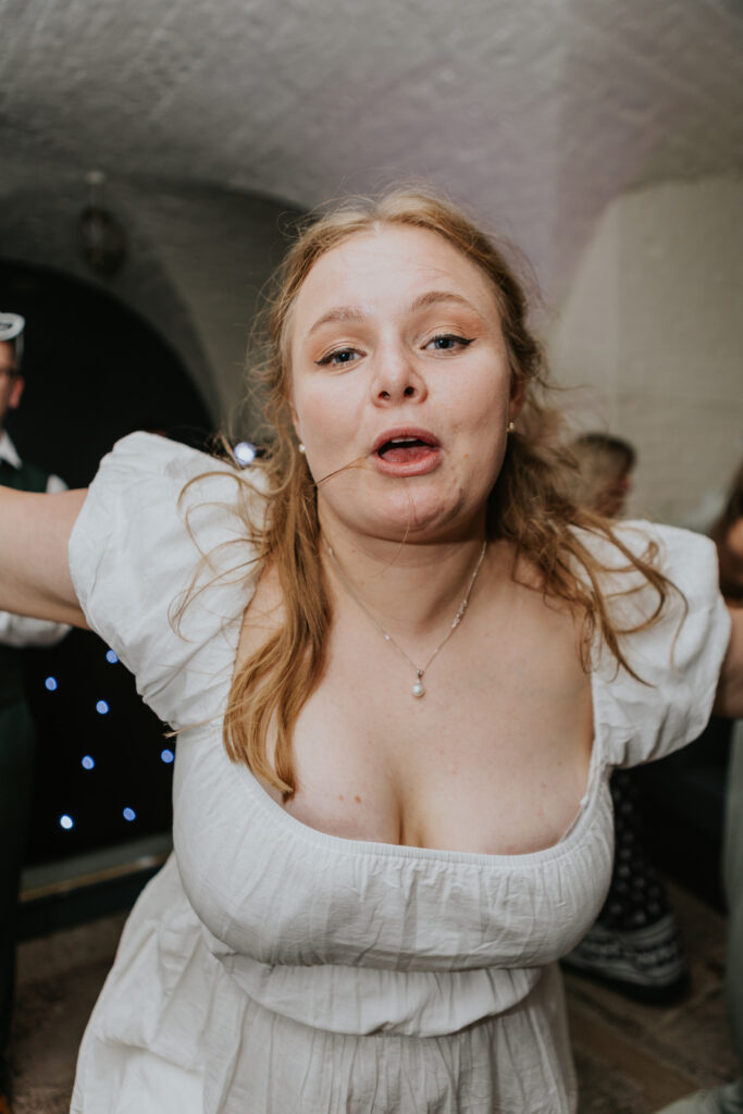 Dancing in the Undercroft at Crowcombe Court during a summer wedding in Somerset, captured by a Crowcombe Court wedding photographer.