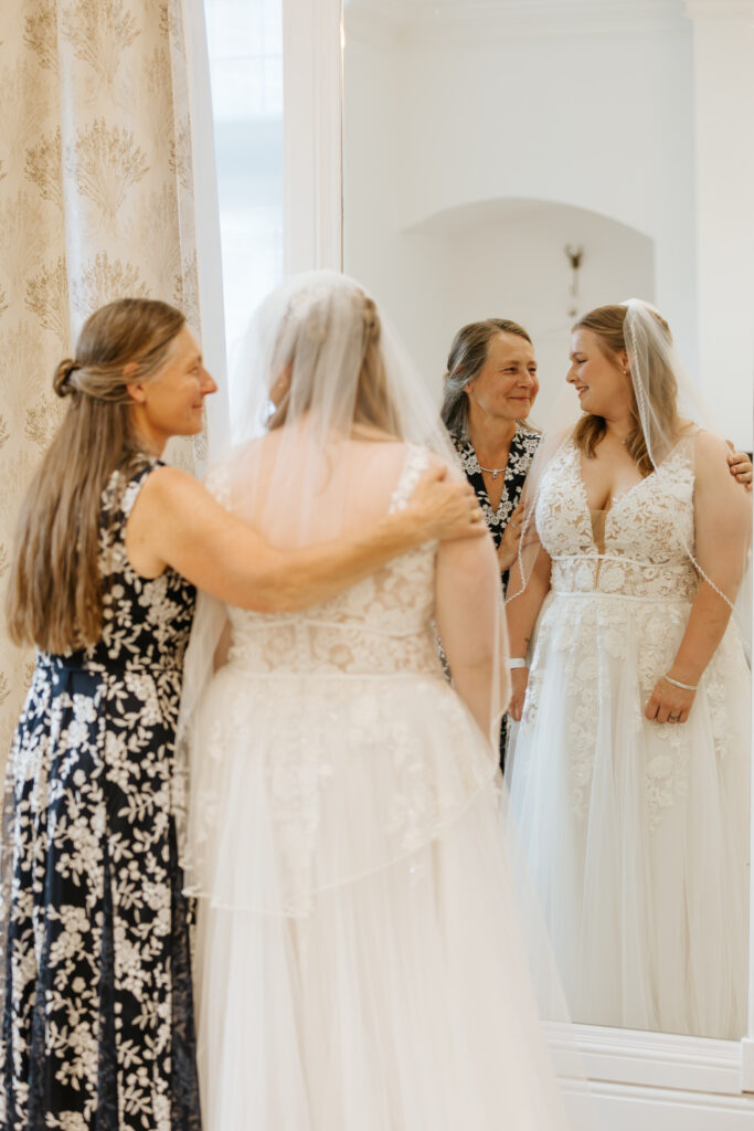 Mother-daughter embrace at Crowcombe Court during a summer wedding in Somerset, captured by a Crowcombe Court wedding photographer.