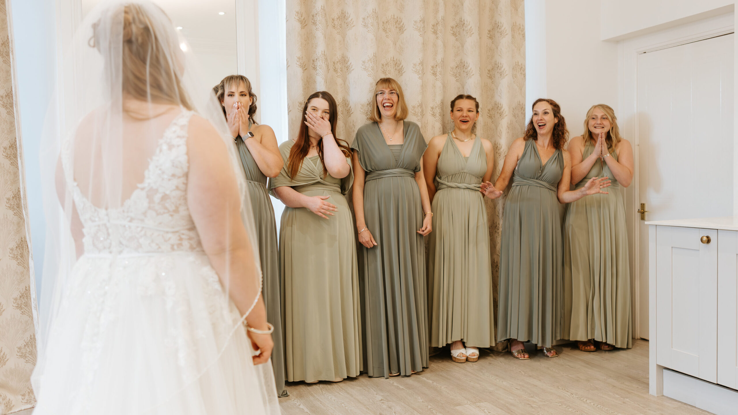 First look with bridesmaids at Crowcombe Court during a summer wedding in Somerset, captured by a Crowcombe Court wedding photographer.