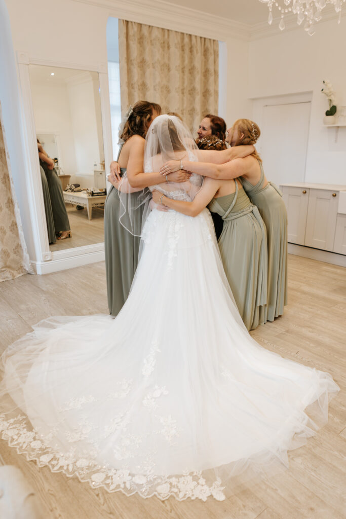 First look with bridesmaids at Crowcombe Court during a summer wedding in Somerset, captured by a Crowcombe Court wedding photographer.