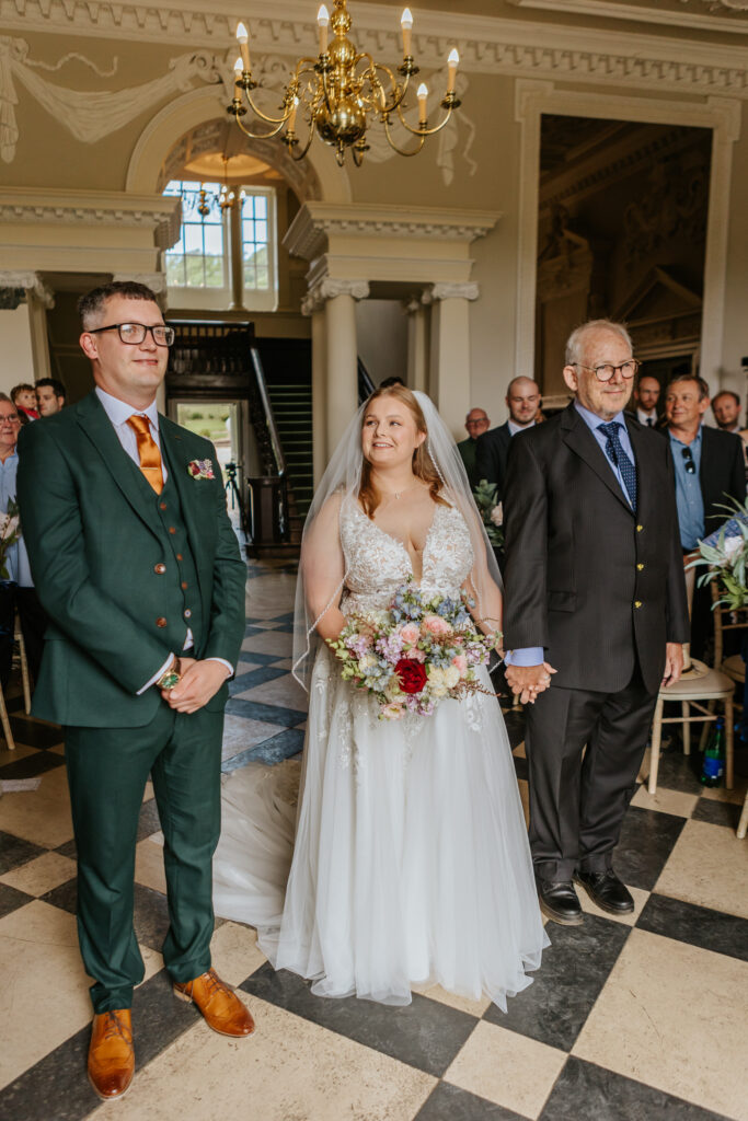 Bride and groom in the great hall at Crowcombe Court during a summer wedding in Somerset, captured by a Crowcombe Court wedding photographer.