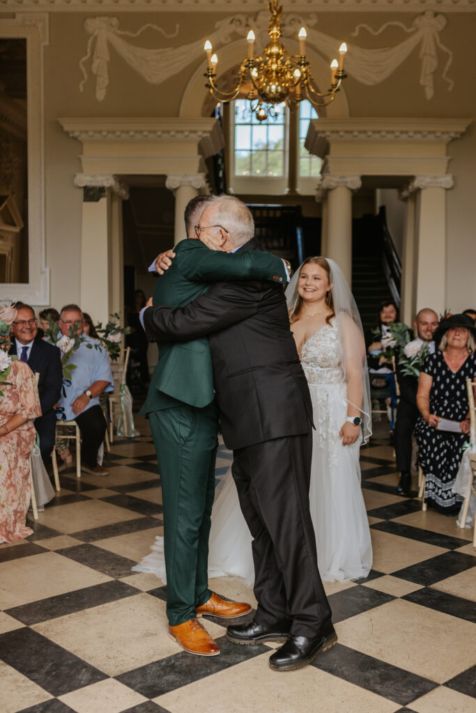 Bride and groom in the great hall at Crowcombe Court during a summer wedding in Somerset, captured by a Crowcombe Court wedding photographer.