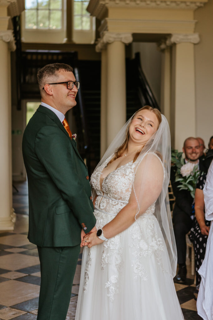 Bride and groom in the great hall at Crowcombe Court during a summer wedding in Somerset, captured by a Crowcombe Court wedding photographer.