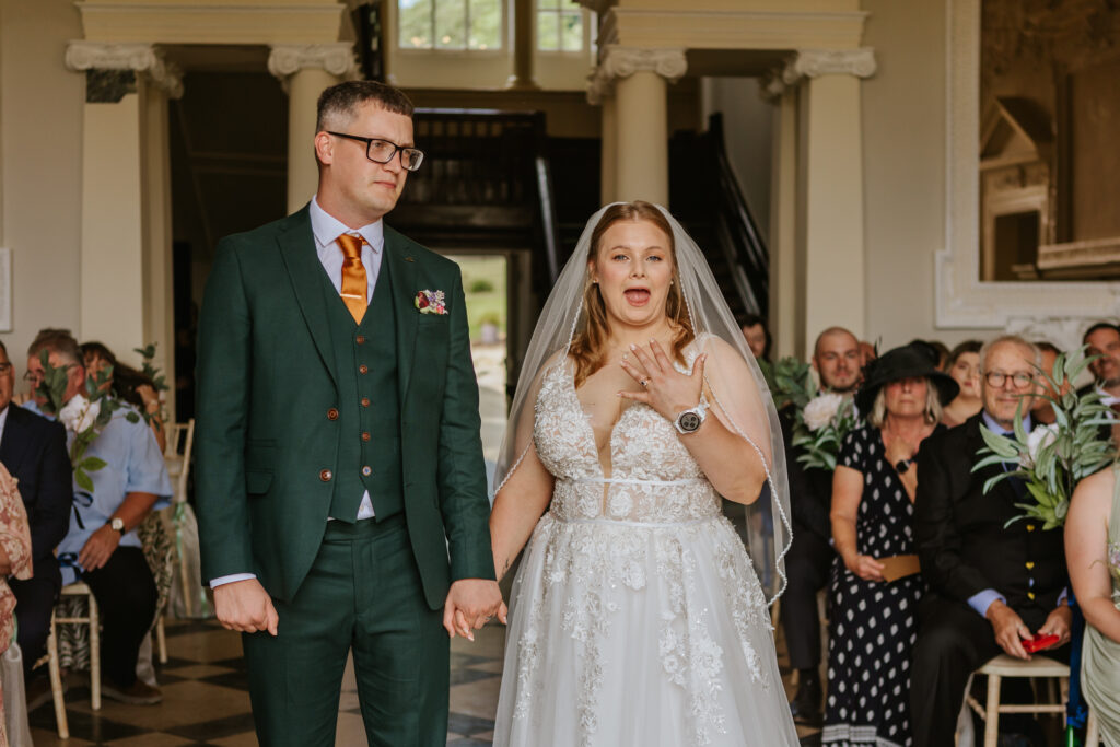 Bride and groom in the great hall at Crowcombe Court during a summer wedding in Somerset, captured by a Crowcombe Court wedding photographer.