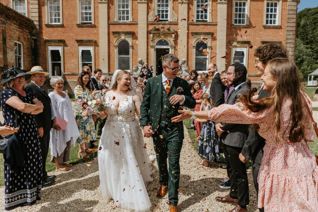 Confetti in the gardens at Crowcombe Court during a summer wedding in Somerset, captured by a Crowcombe Court wedding photographer.