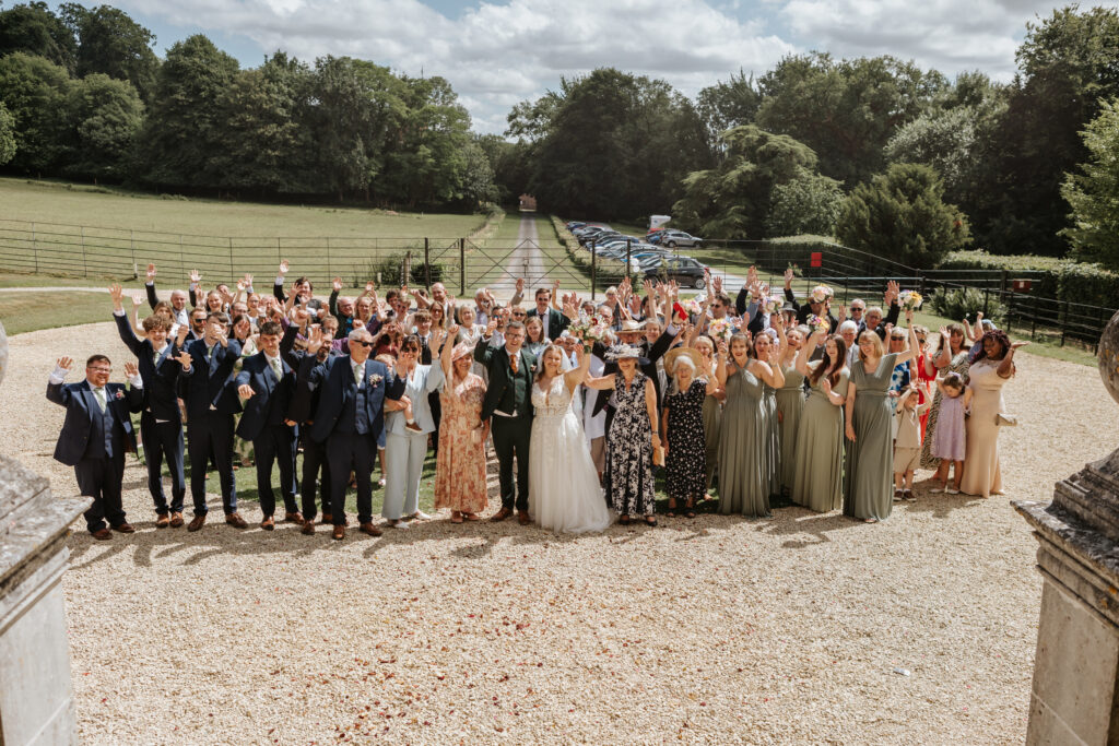 Group Photo in the gardens at Crowcombe Court during a summer wedding in Somerset, captured by a Crowcombe Court wedding photographer.
