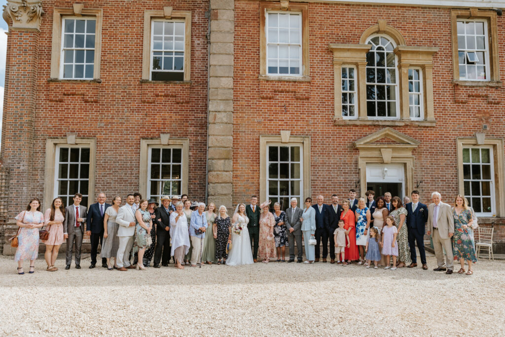 Group Photos in the gardens at Crowcombe Court during a summer wedding in Somerset, captured by a Crowcombe Court wedding photographer.