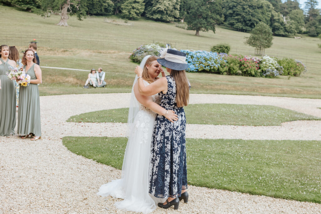Mother daughter dance in the gardens at Crowcombe Court during a summer wedding in Somerset, captured by a Crowcombe Court wedding photographer.