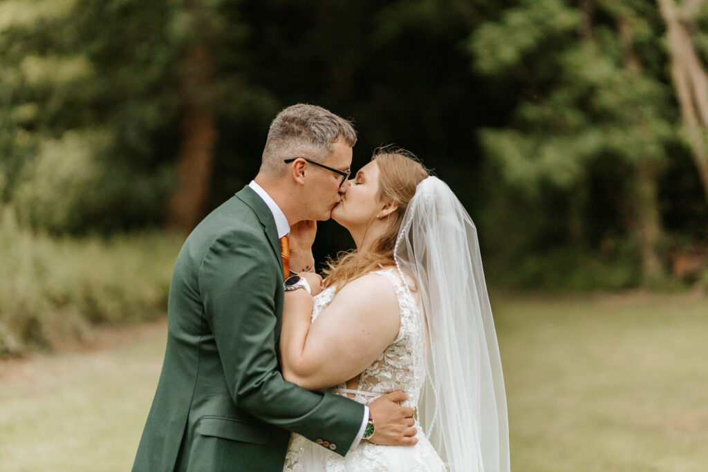 Couple Photos in the gardens at Crowcombe Court during a summer wedding in Somerset, captured by a Crowcombe Court wedding photographer.