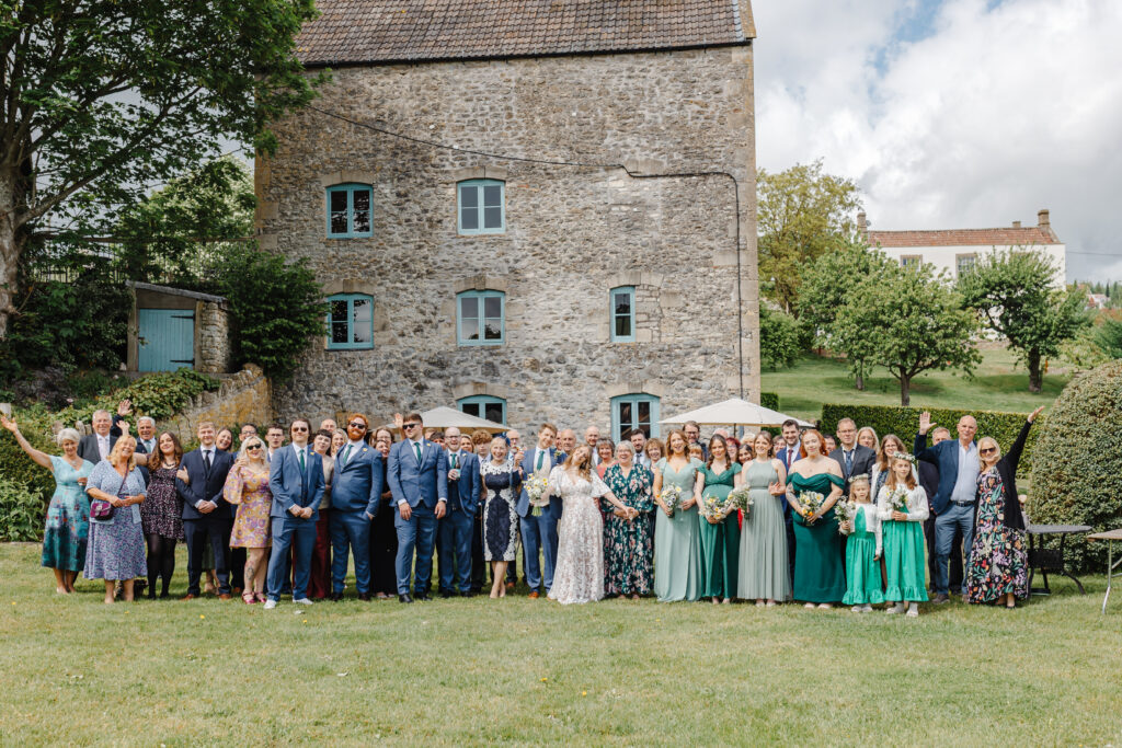 Group Photo of the wedding party outside The Watermill at Priston Mill near Bath