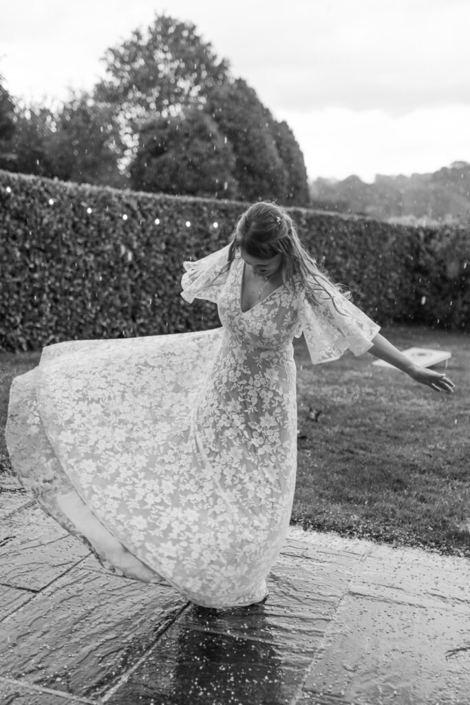 Bride Hannah dancing in the hail at Priston Mill near Bath