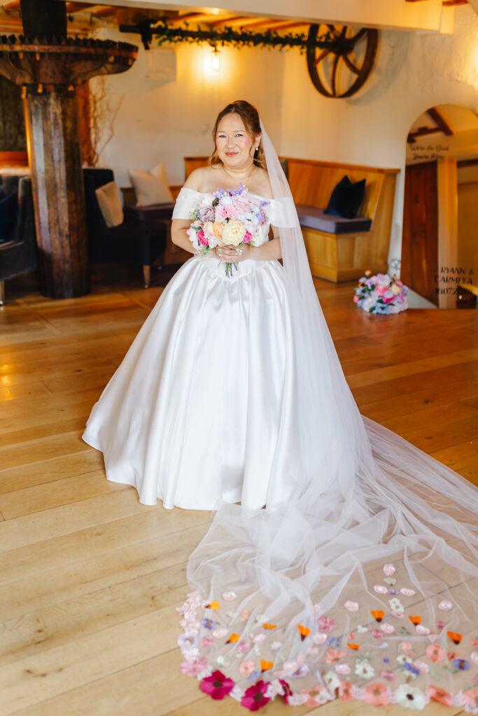 Bride getting ready to walk down the aisle in The Watermill at Priston Mill near Bath with beautiful Bridgeton style bouquet