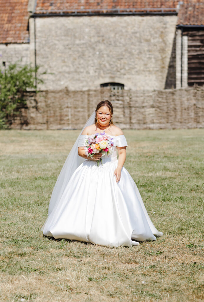 Bride walking down the aisl at The Watermill at Priston Mill near Bath