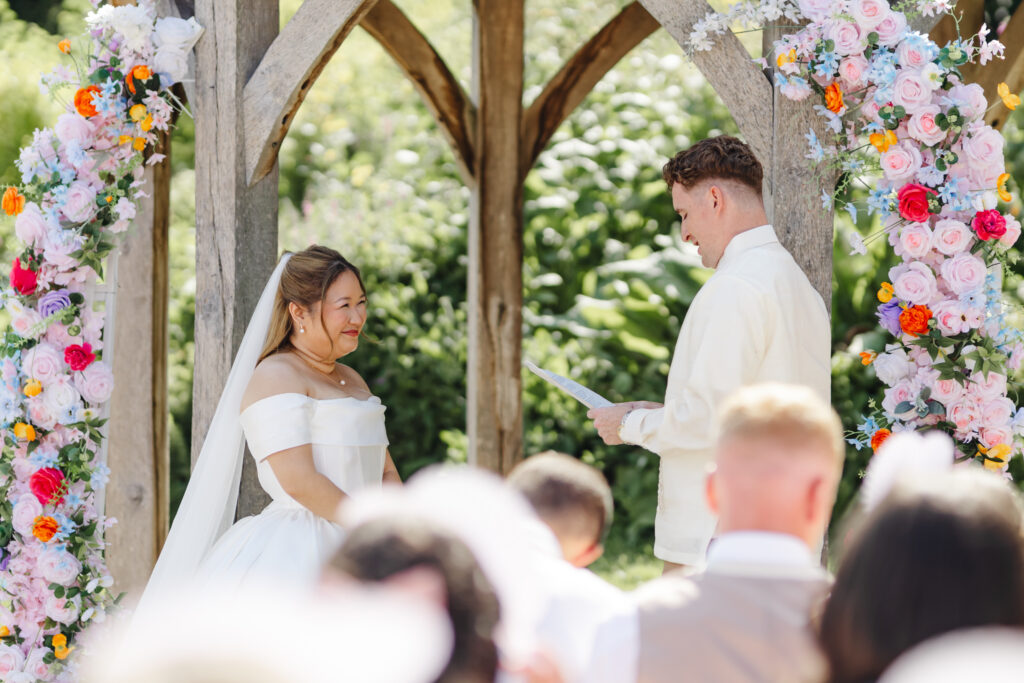 Wedding Ceremony at Priston Mill near Bath with Bridgeton style decor and flower arch