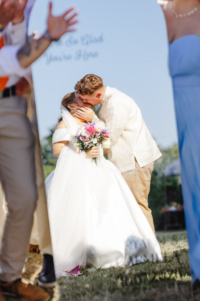 Bride and groom kissing reflection in mirror at Priston Mill near Bath
