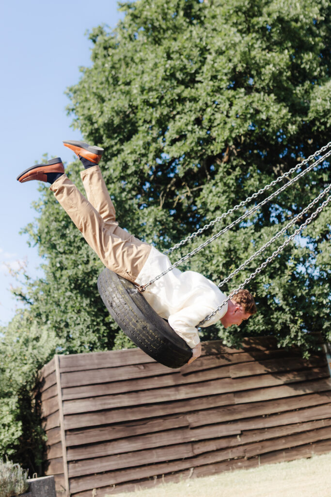 Groom on a tire swing at Priston Mill near Bath