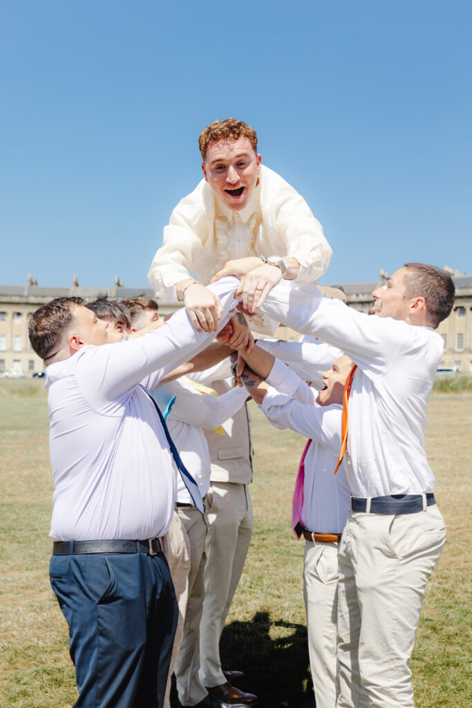 Groom being thrown in the air at the Royal Crescent in Bath