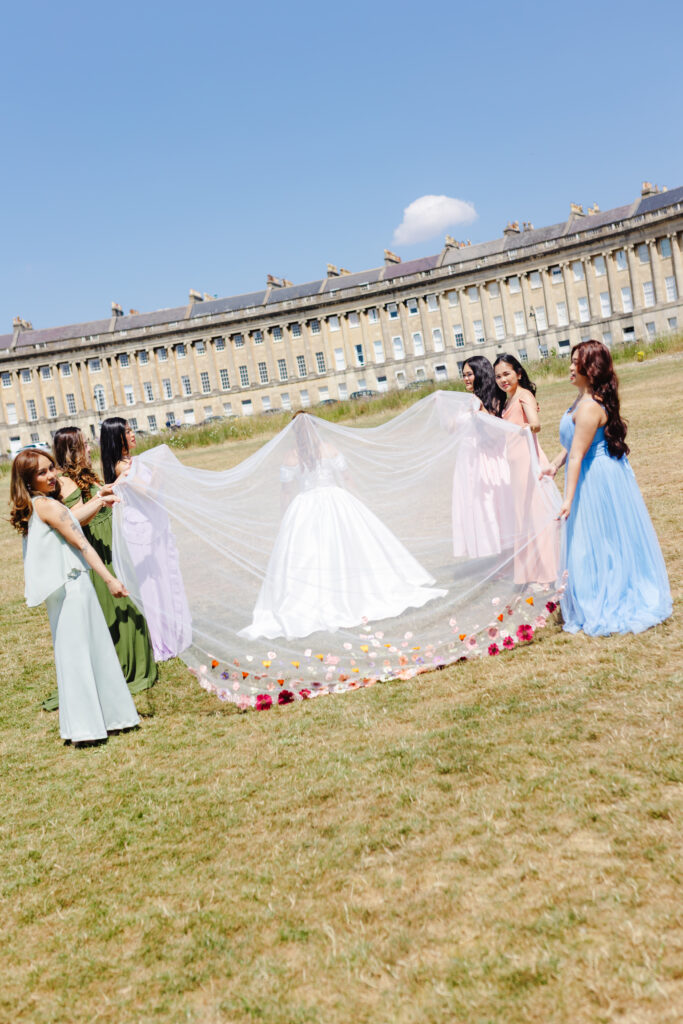 Bride's veil being held by bridesmaids at the Royal Crescent in Bath