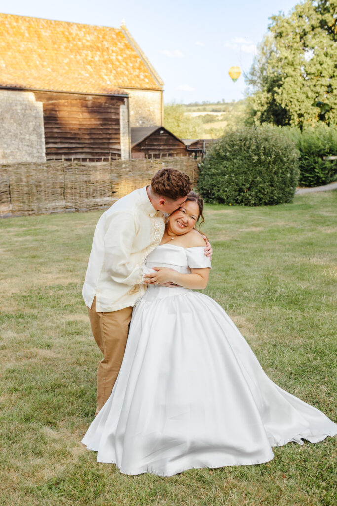 Bride and groom in front of a hot air balloon at Priston Mill near Bath